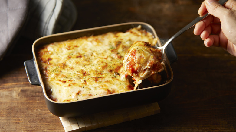 serving lasagna with spoon
